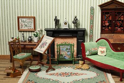 Dollhouse room showing a range of needlepoint items in the design Barbara green