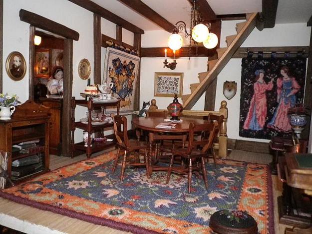 Tudor room showing dollhouse needlepoint carpet "Elizabeth", "Jessica" footstool, "Cluny Women" wallhanging and "Love Is Enough" sampler