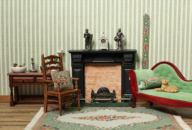 A dollhouse room with needlepoint items featuring the "Barbara (green)" design