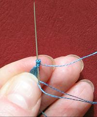 Pass needle out through the top