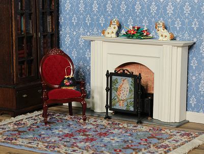 Picture of a room with a carpet and several other needlepoint items