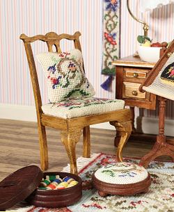 A dollhouse room with a dining chair
