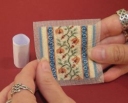 Piece of stitching and roll of card