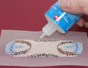 Miniature needlepoint tutorial - run a line of fabric glue around the edge of the stitching