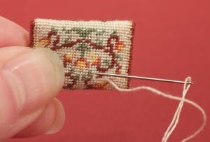 Miniature needlepoint tutorial - make a couple of backstitches on the back