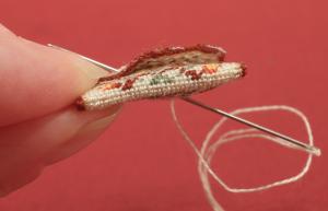 Miniature needlepoint tutorial - poke your needle from the back to the front of the bag