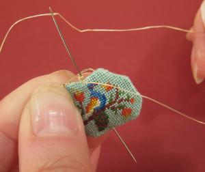 Miniature needlepoint tutorial - Attach the bead, passing the needle through the bead twice